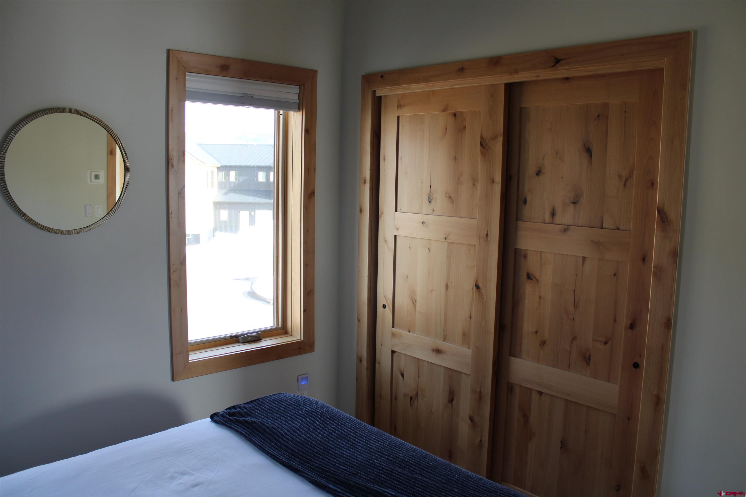 101 Elk Valley Road, Unit C Crested Butte, CO 81224 - Photo 16 of 41 a view of bedroom with window and wooden floor