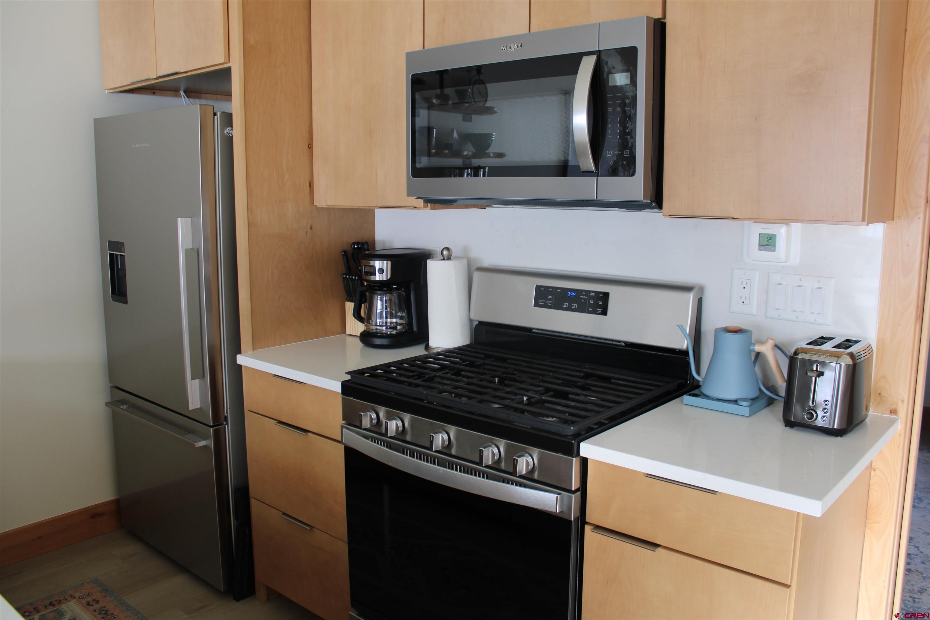 101 Elk Valley Road, Unit C Crested Butte, CO 81224 - Photo 5 of 41 a kitchen with a stove and a microwave