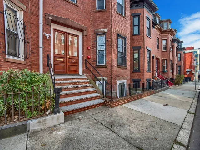 a view of a brick building with many windows
