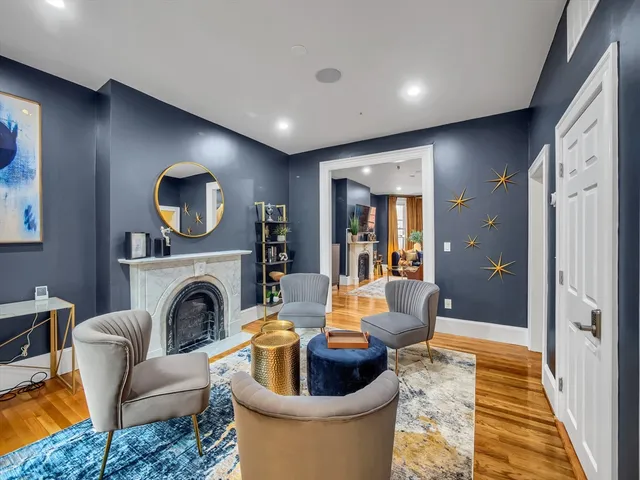a living room with furniture a fireplace and a flat screen tv