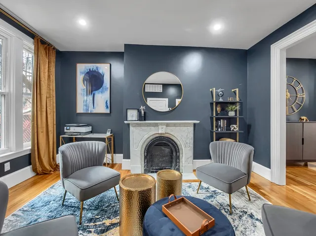 a living room with furniture and a fireplace