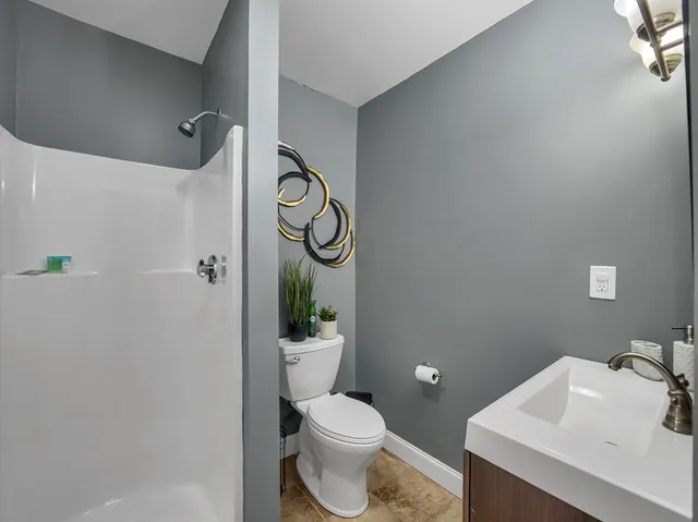 a white toilet sitting next to a bathroom sink