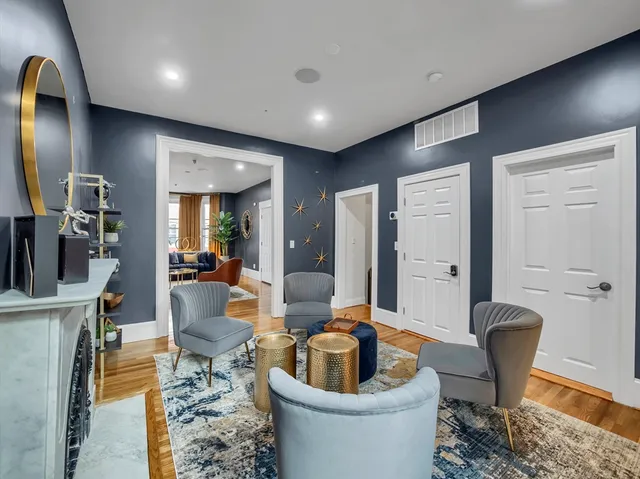 a living room with furniture a mirror and toilet