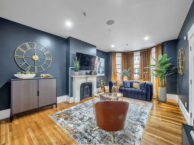 a living room with furniture a rug and a fireplace