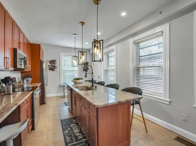 a kitchen with sink stove and cabinets