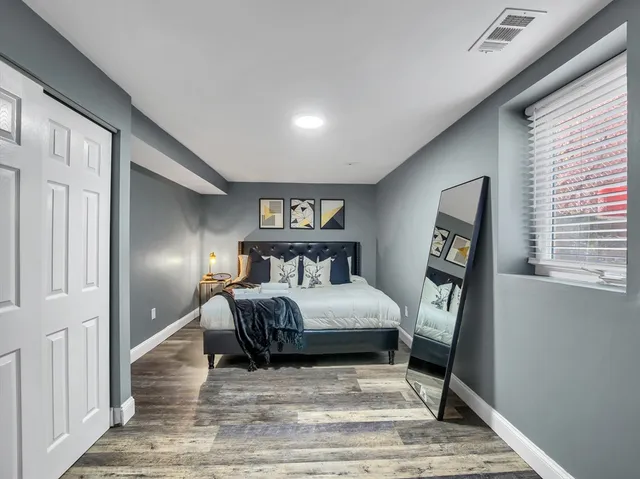 a bedroom with a bed and window