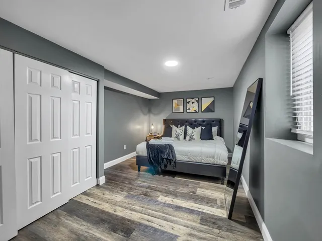 a bedroom with a large bed and a window