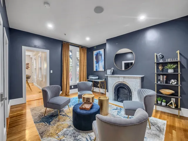a living room with furniture a fireplace and a flat screen tv