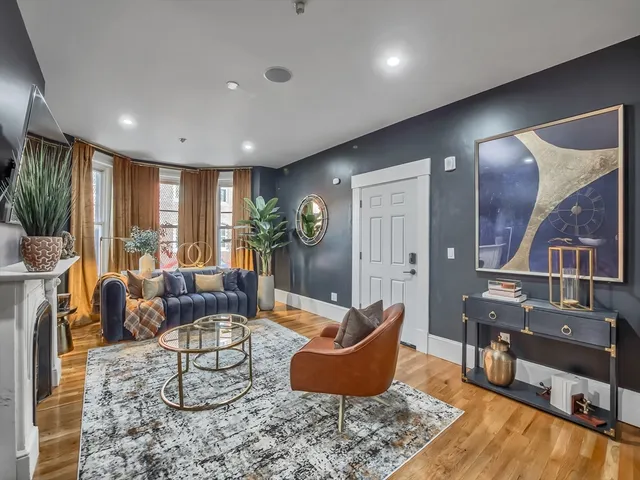 a living room with furniture and wooden floor