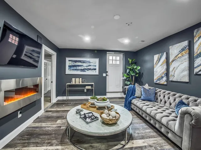 a living room with furniture and a fireplace