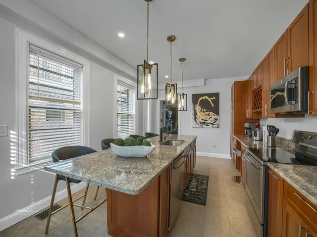 a kitchen with sink cabinets and living room view