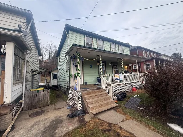 a view of house with yard and sitting area