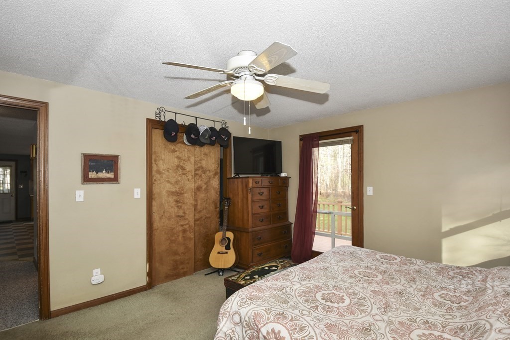 11 Hospital Road Templeton, MA 01436 - Photo 12 of 28 a bedroom with a bed and a chandelier