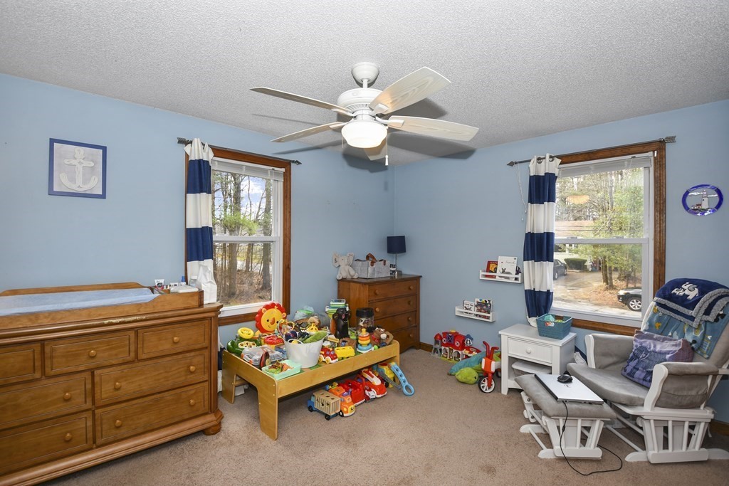 11 Hospital Road Templeton, MA 01436 - Photo 17 of 28 a bedroom with a bed and a chandelier