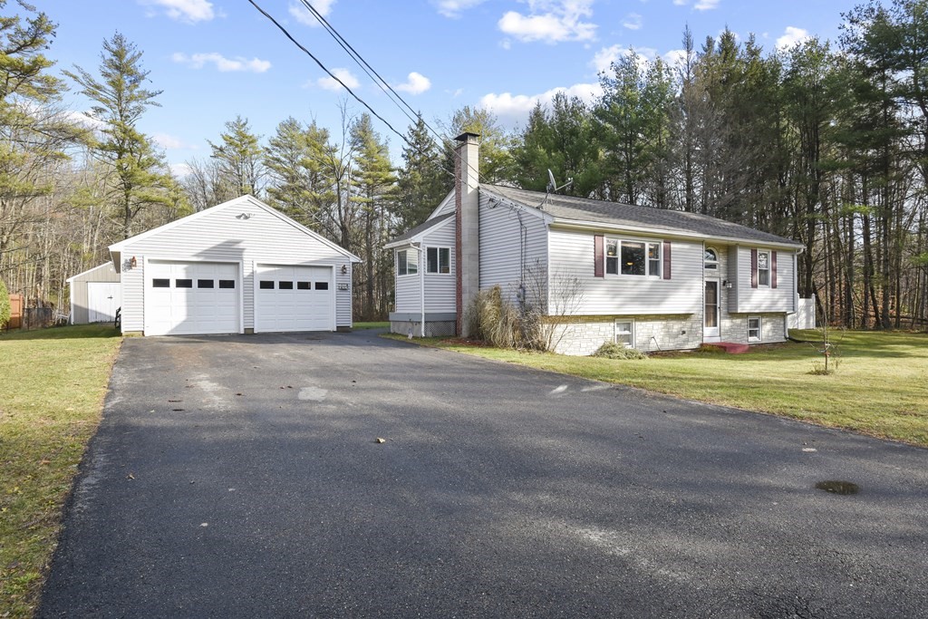11 Hospital Road Templeton, MA 01436 - Photo 3 of 28 a front view of a house with a yard and garage