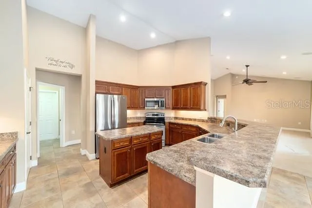 a view of kitchen with center island and stainless steel appliances