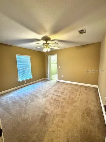 a view of a livingroom with a ceiling fan and window
