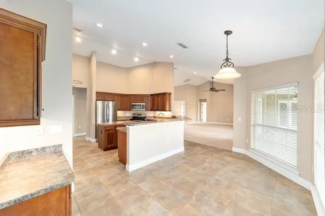 a spacious bathroom with a granite countertop sink a mirror and a shower