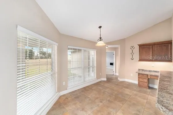 a spacious bathroom with a double vanity sink mirror and next to a window