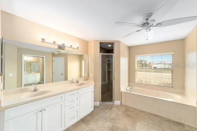 a view of a room with a ceiling fan and a window