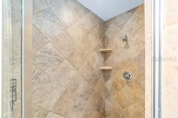 a spacious bathroom with a bathtub shower and a sink