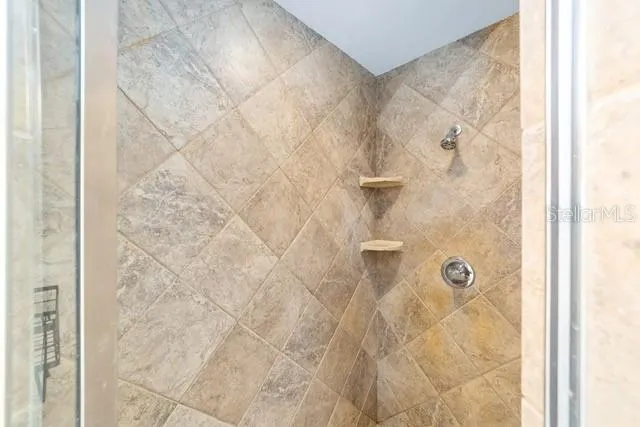 a spacious bathroom with a bathtub shower and a sink