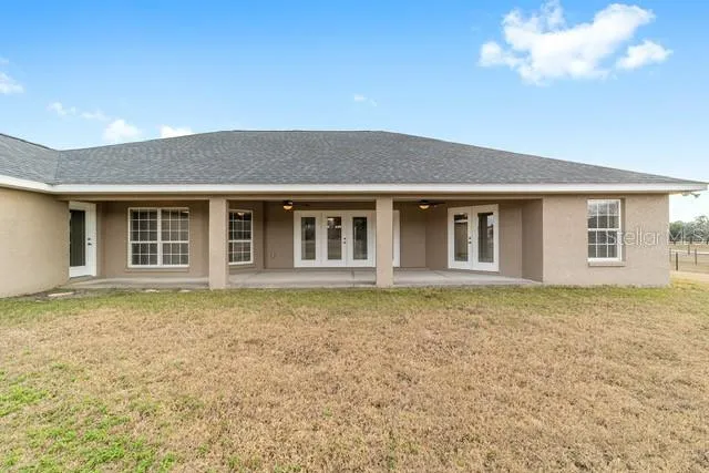 a view of a swimming pool with a yard and mountain view