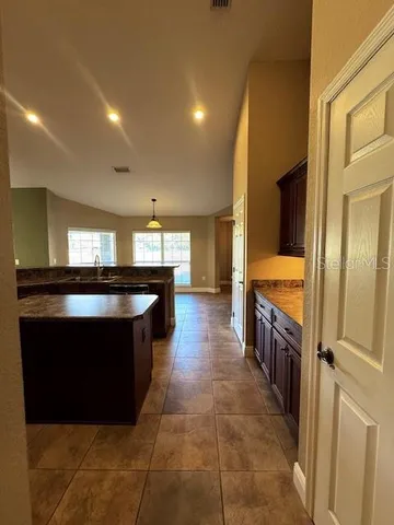 a kitchen with stainless steel appliances a sink stove and cabinets