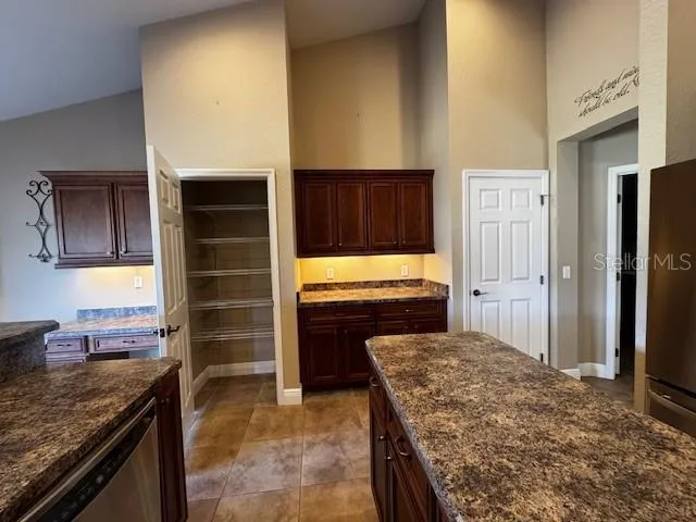 a kitchen with a stove and a refrigerator