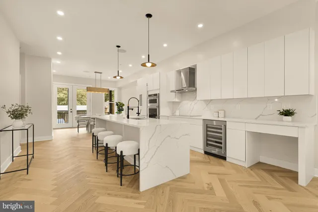 a kitchen with cabinets and chairs
