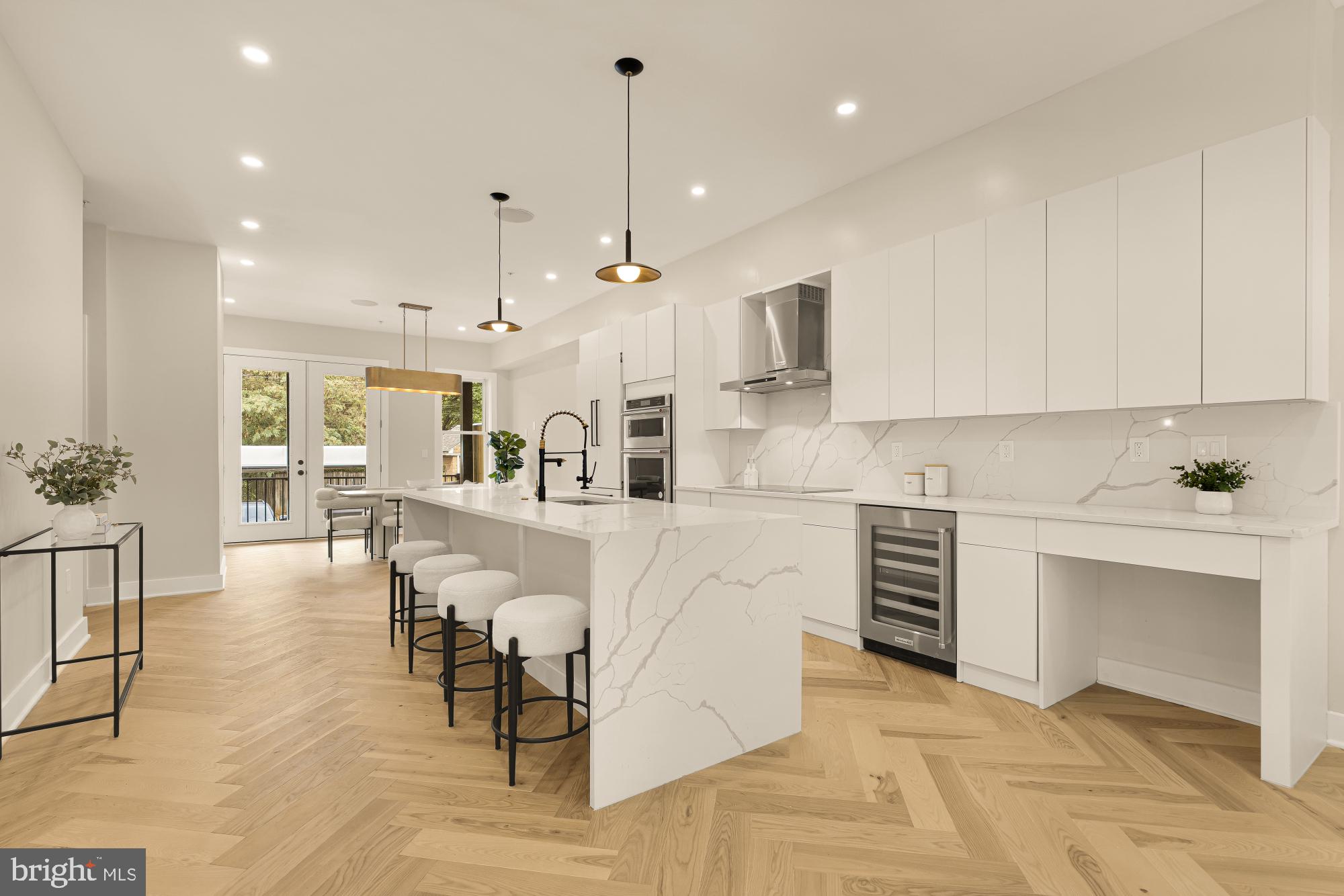 3703 Reservoir Road Northwest Washington, DC 20007 - Photo 11 of 60 a large white kitchen with lots of counter space a sink appliances and cabinets