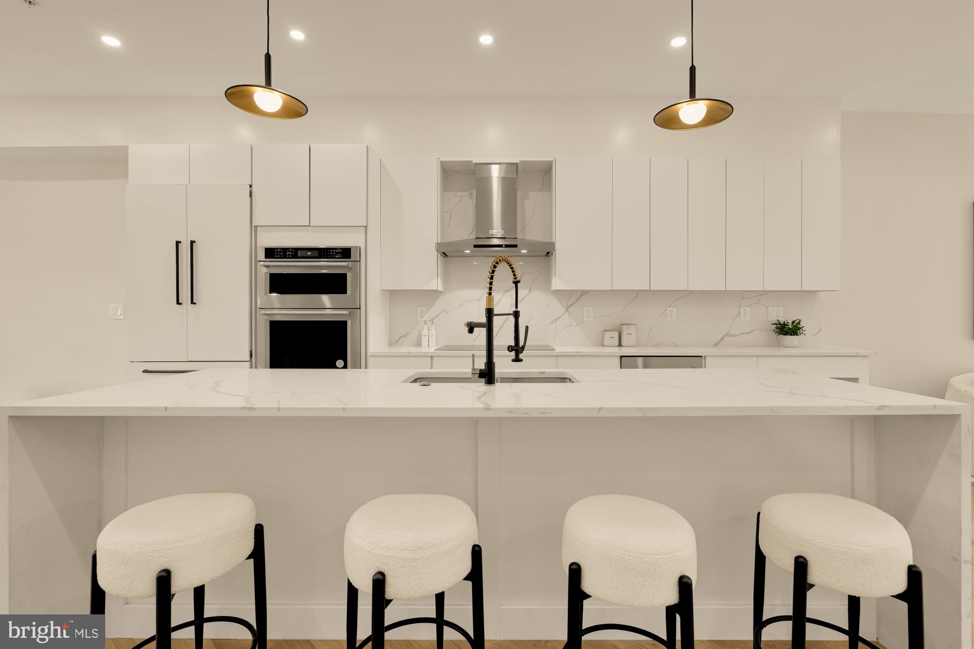 3703 Reservoir Road Northwest Washington, DC 20007 - Photo 13 of 60 a kitchen with stainless steel appliances a sink and cabinets