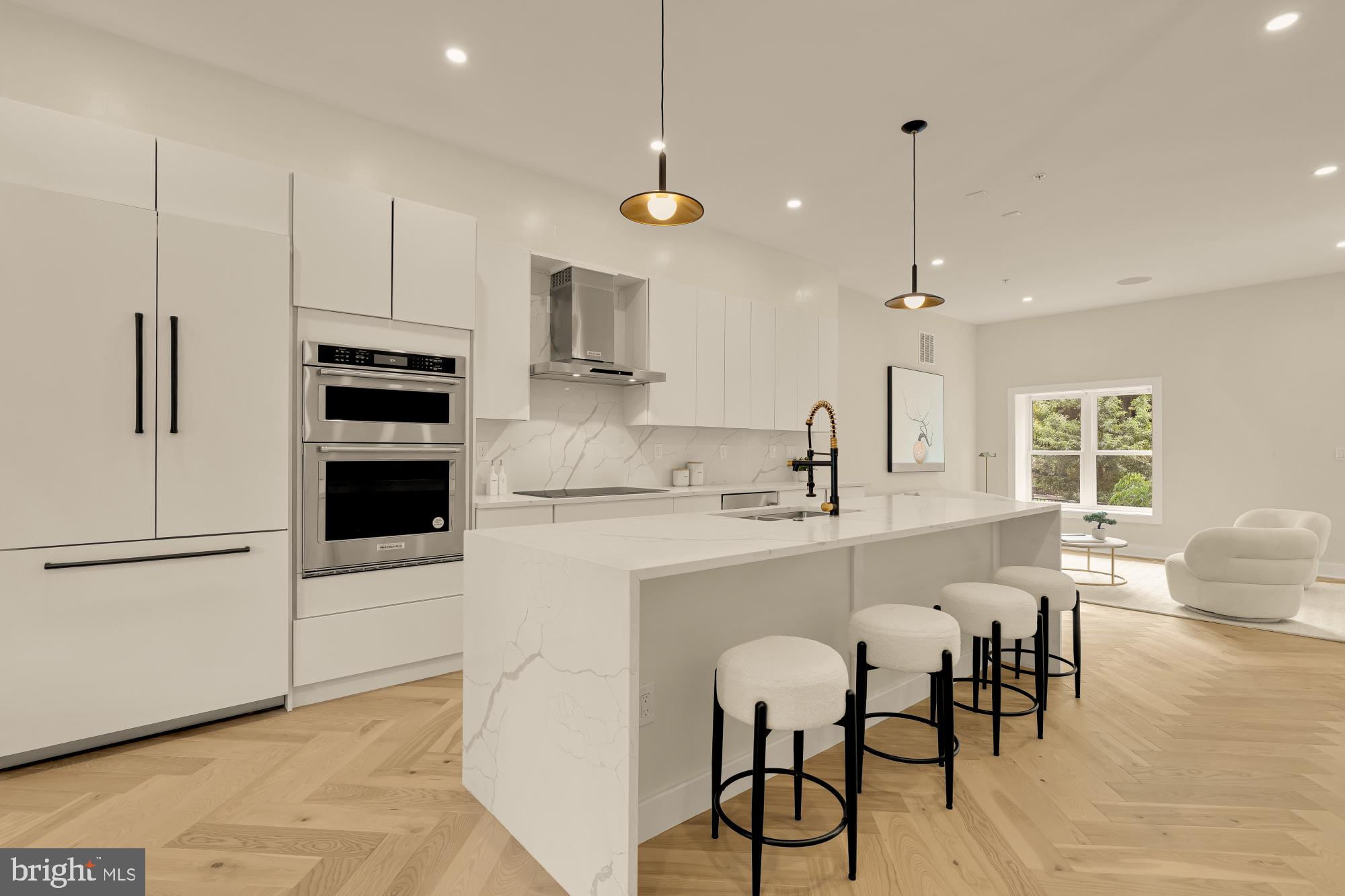 3703 Reservoir Road Northwest Washington, DC 20007 - Photo 14 of 60 a kitchen with stainless steel appliances a stove a sink island and a refrigerator with wooden floor