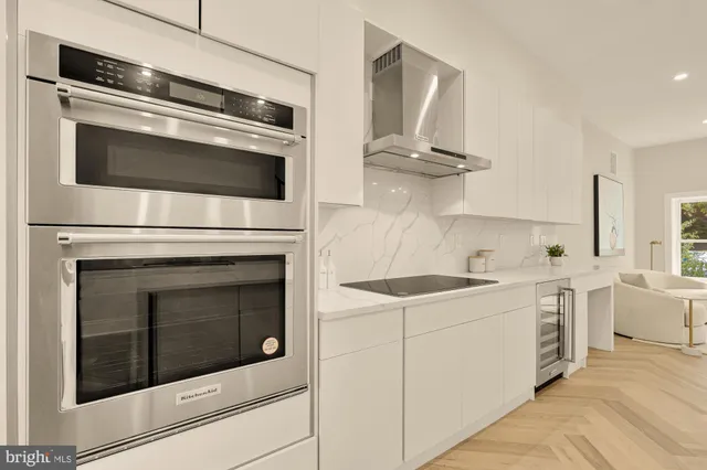 a large kitchen with granite countertop a sink and a large window