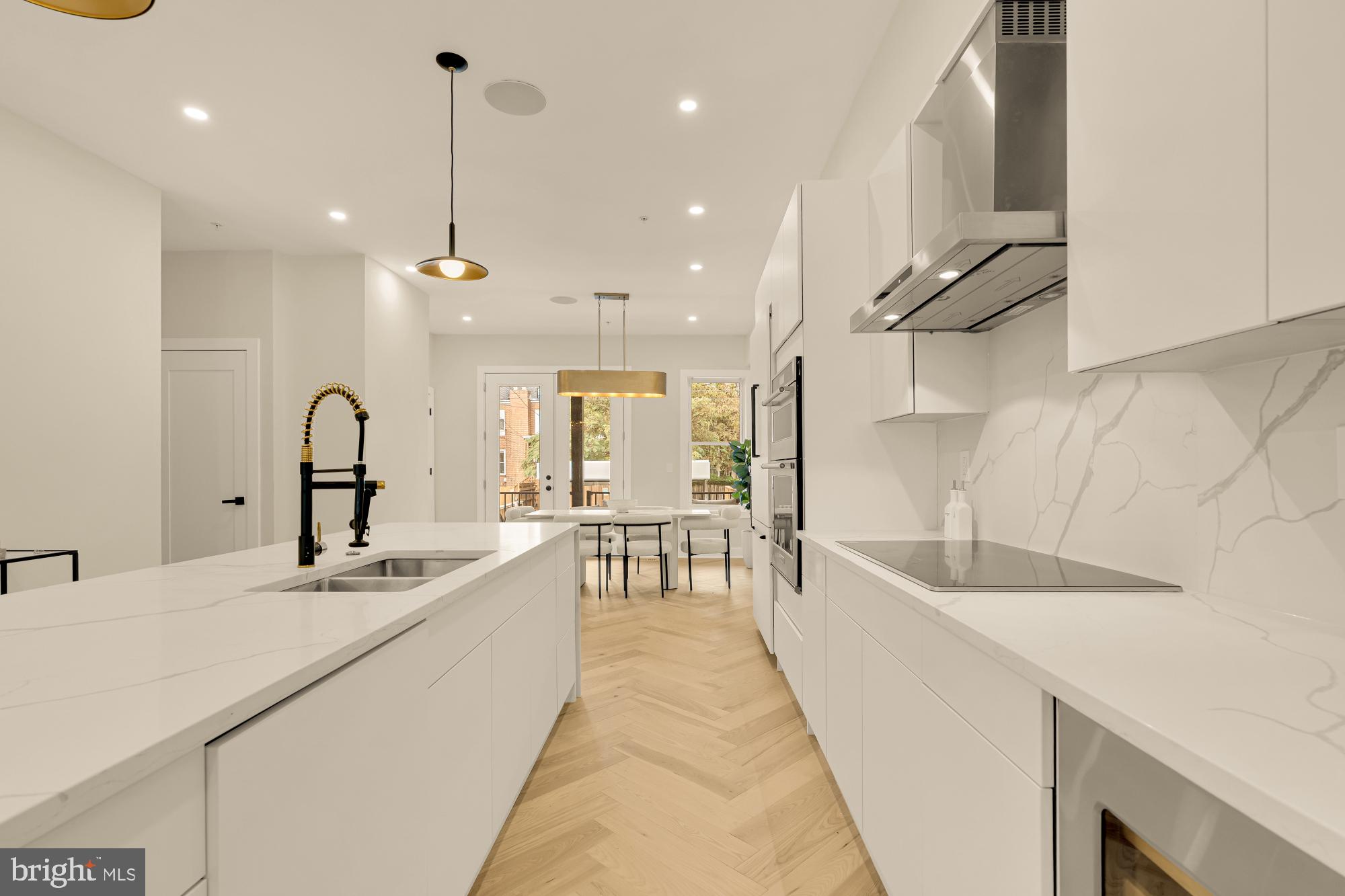 3703 Reservoir Road Northwest Washington, DC 20007 - Photo 18 of 60 a large kitchen with granite countertop a sink and a large window