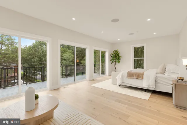 a spacious bedroom with a large bed and a large window