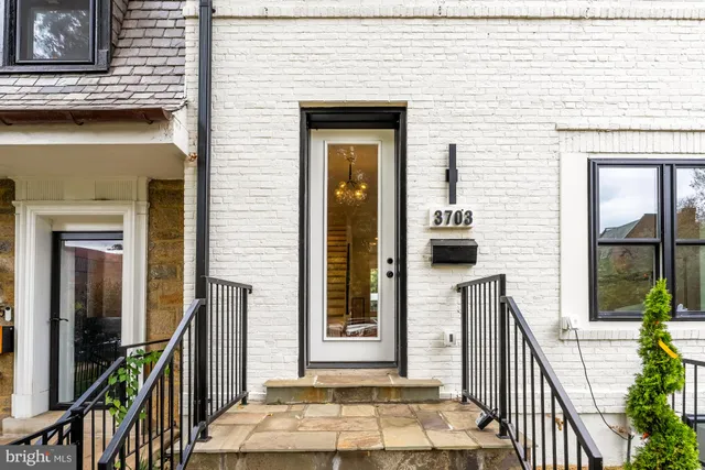 a living room with stainless steel appliances kitchen island furniture and a view of kitchen