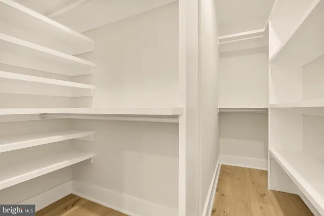 a living room with furniture and a refrigerator