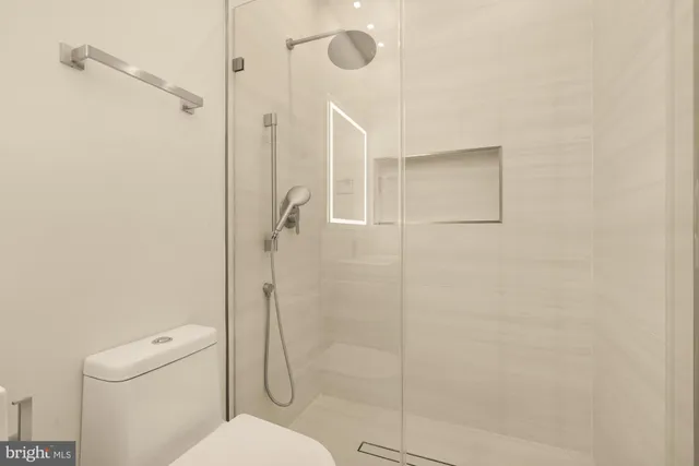 a kitchen with white cabinets and refrigerator