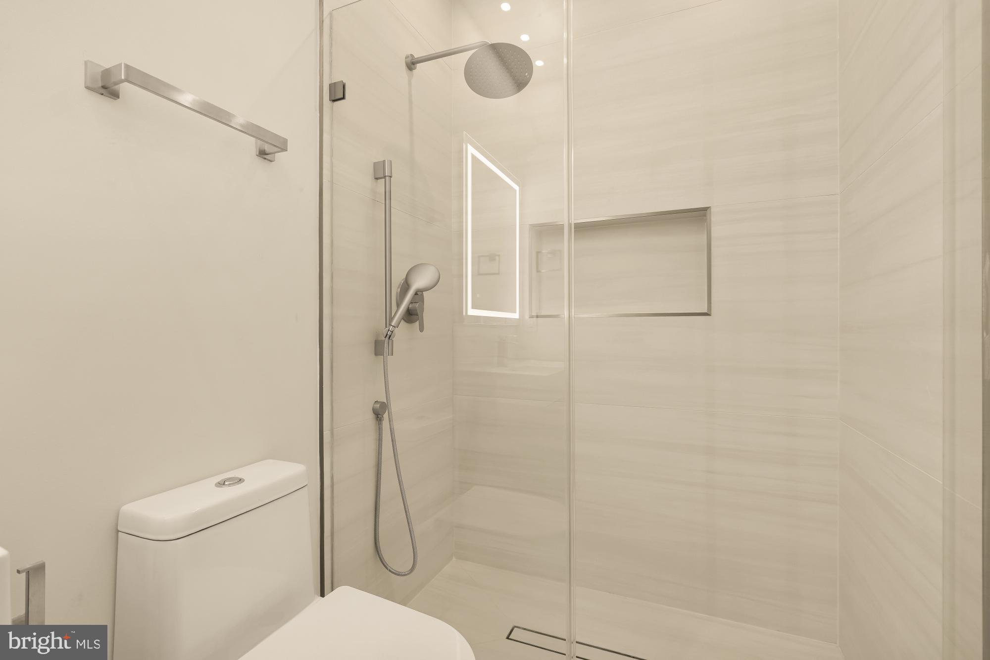 3703 Reservoir Road Northwest Washington, DC 20007 - Photo 44 of 60 a bathroom with a shower a toilet and a shower