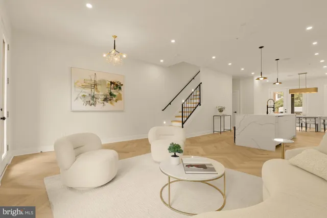 a large white kitchen with lots of counter space a sink appliances and cabinets