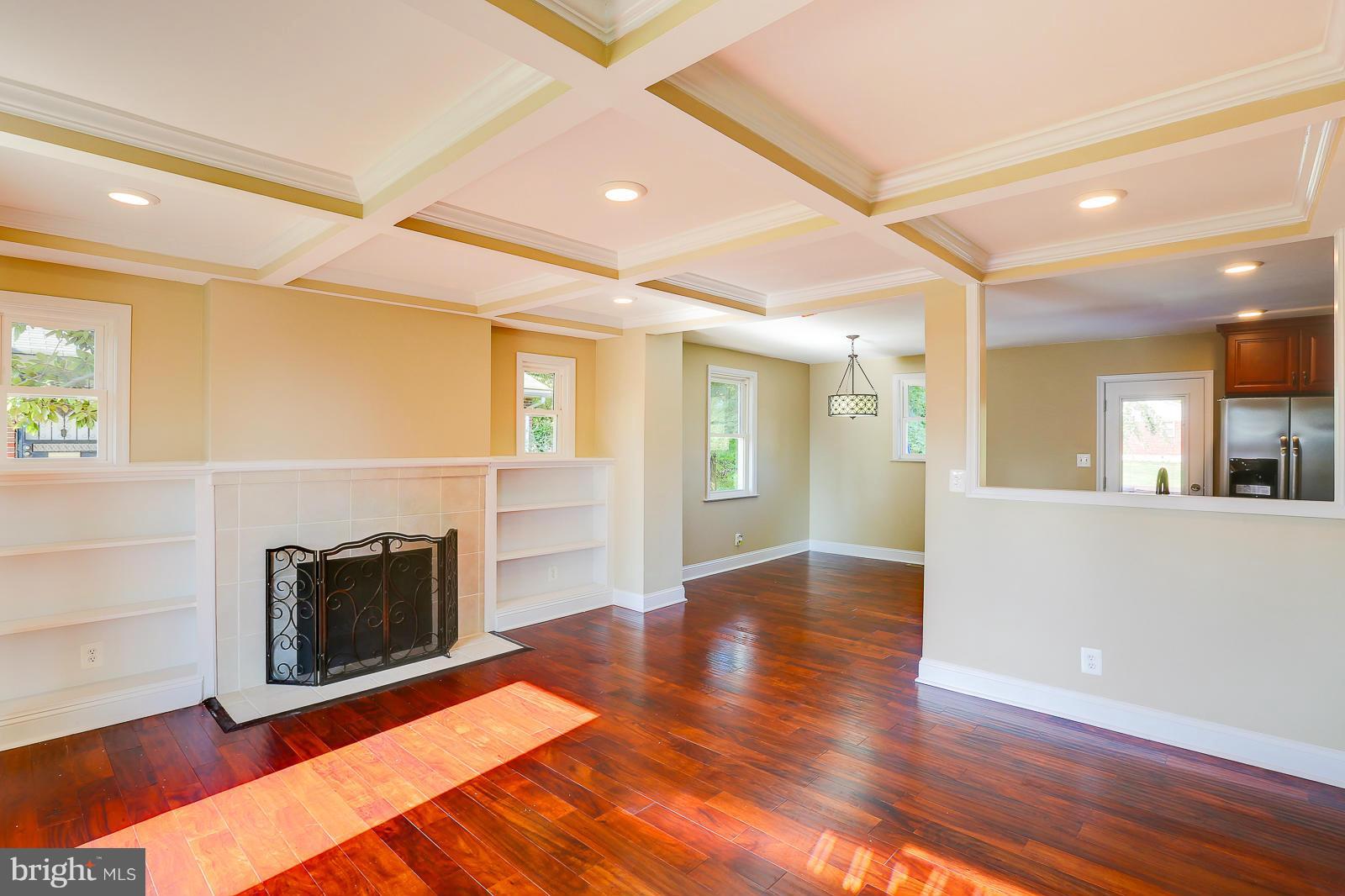 3216 Mayfair Road Baltimore, MD 21207 - Photo 2 of 24 a view of a livingroom with wooden floor and a fireplace