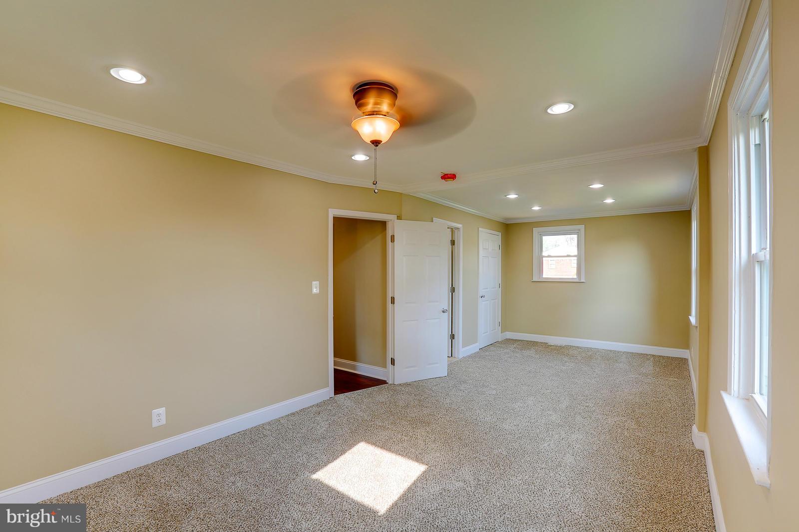 3216 Mayfair Road Baltimore, MD 21207 - Photo 12 of 24 an empty room with a window and chandelier