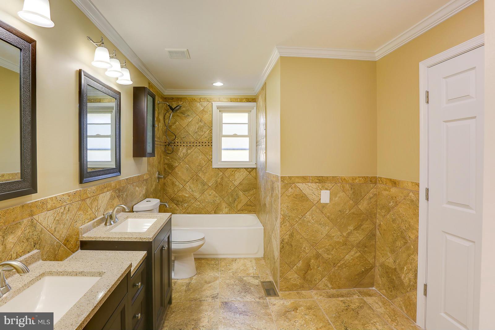 3216 Mayfair Road Baltimore, MD 21207 - Photo 13 of 24 a bathroom with a granite countertop sink and a mirror