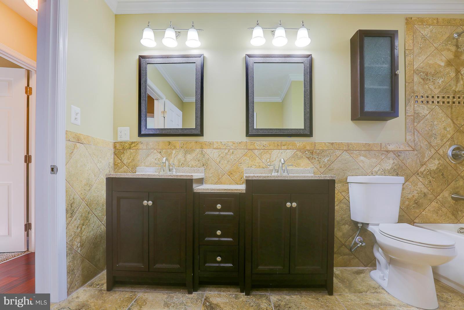 3216 Mayfair Road Baltimore, MD 21207 - Photo 14 of 24 a bathroom with a toilet sink and mirror