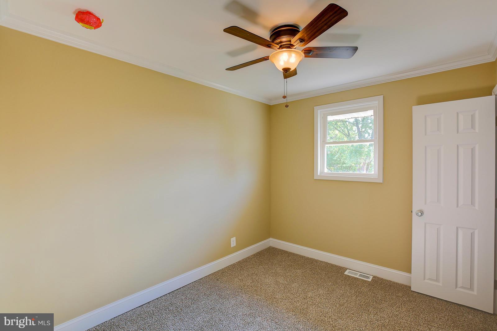 3216 Mayfair Road Baltimore, MD 21207 - Photo 15 of 24 an empty room with a ceiling fan and a window