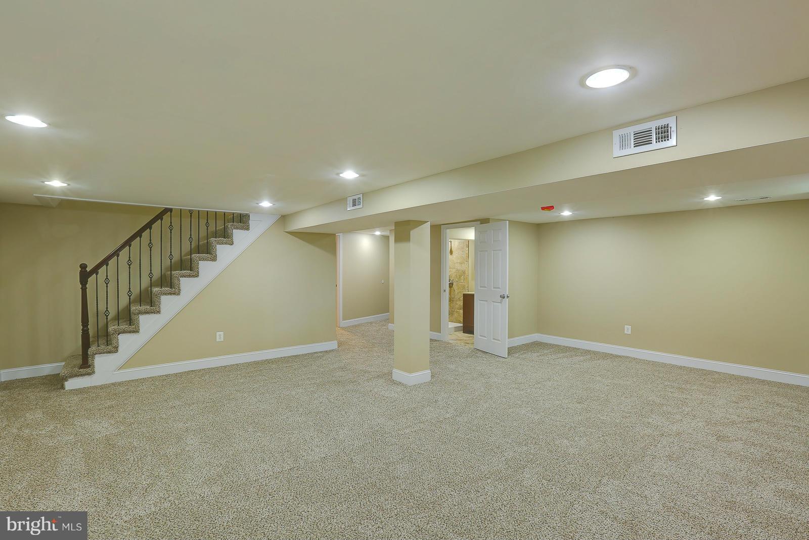3216 Mayfair Road Baltimore, MD 21207 - Photo 17 of 24 an empty room with wooden floor and windows