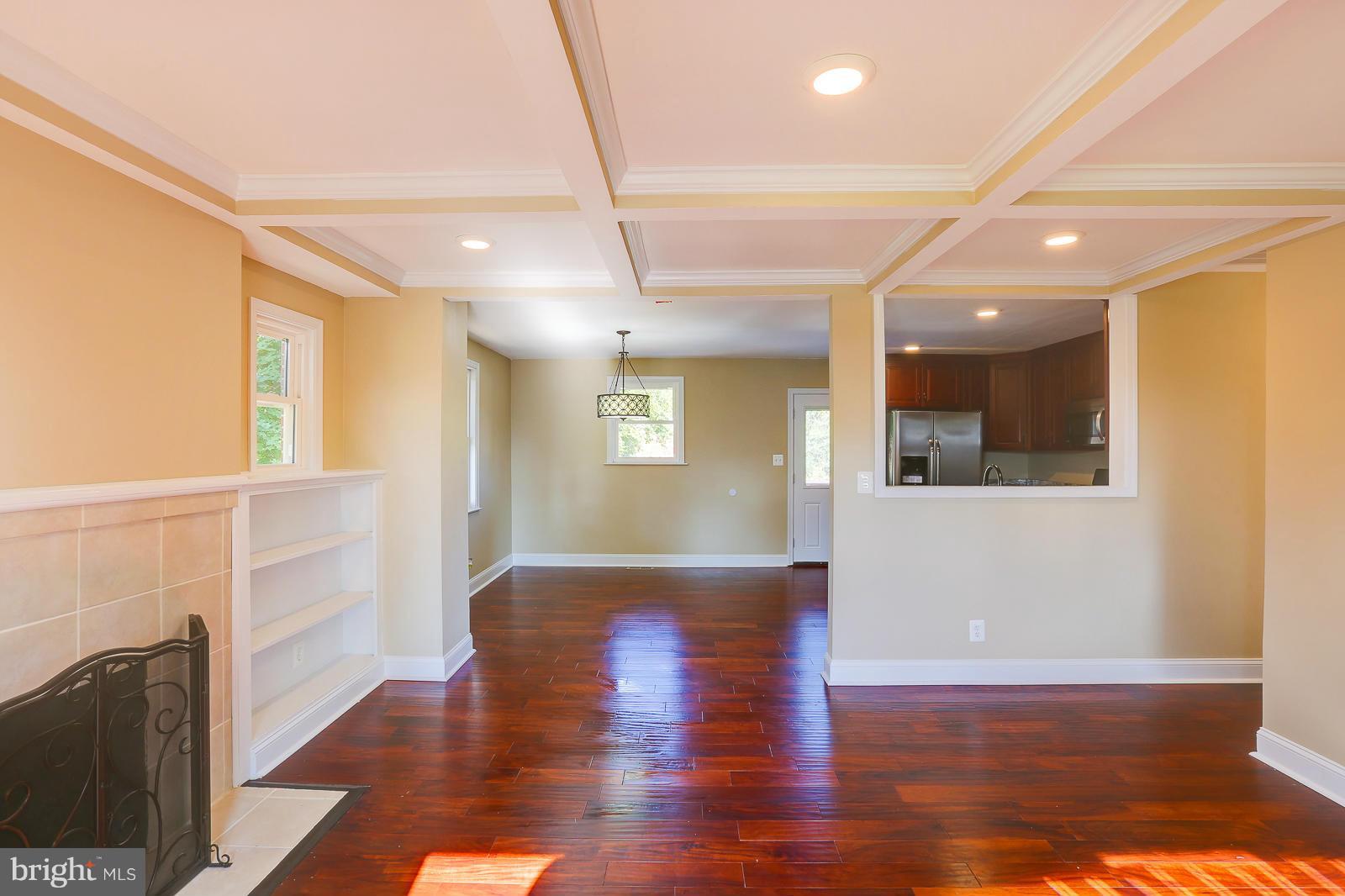 3216 Mayfair Road Baltimore, MD 21207 - Photo 5 of 24 a view of hallway with a window and wooden floor