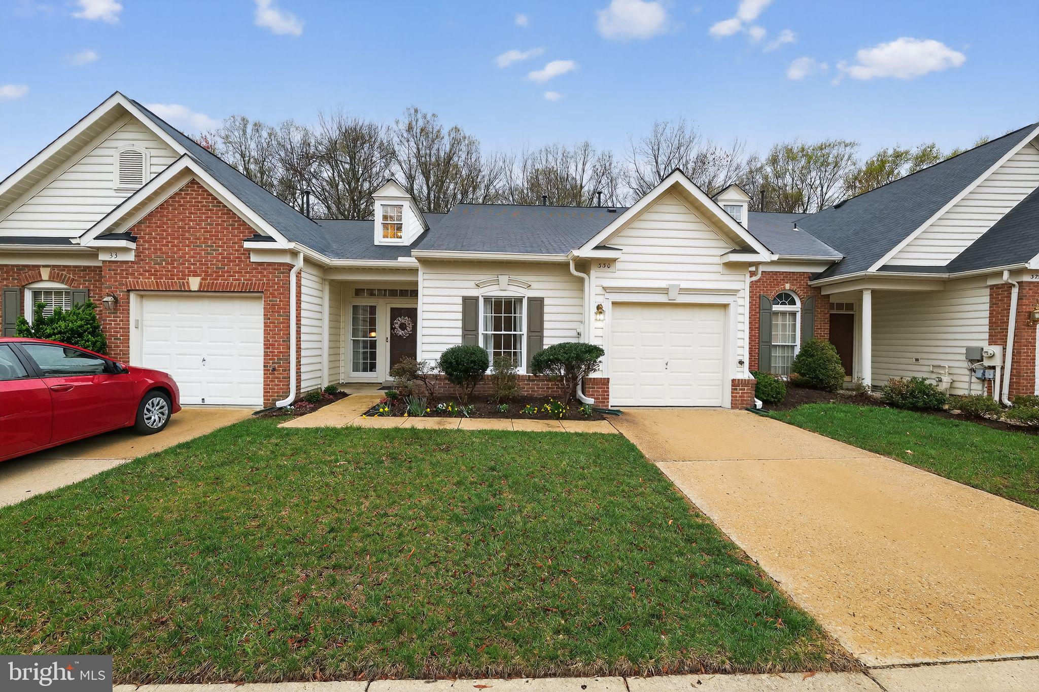 330 Colony Point Place Edgewater, MD 21037 - Photo 2 of 57 a front view of a house with a yard and garage