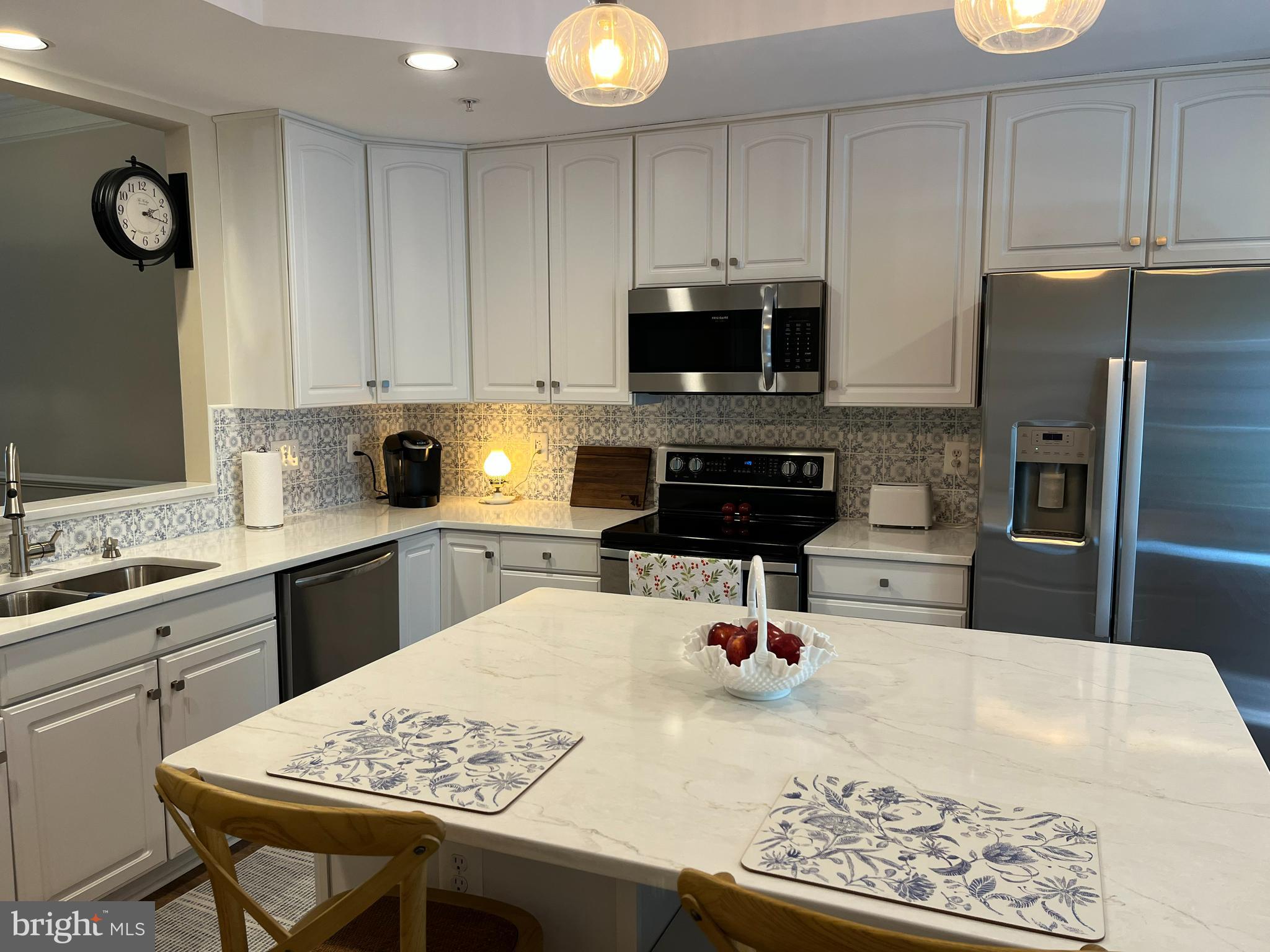 330 Colony Point Place Edgewater, MD 21037 - Photo 22 of 57 a kitchen with stainless steel appliances kitchen island granite countertop a sink dishwasher a stove a refrigerator a microwave oven with white cabinets and wooden floor